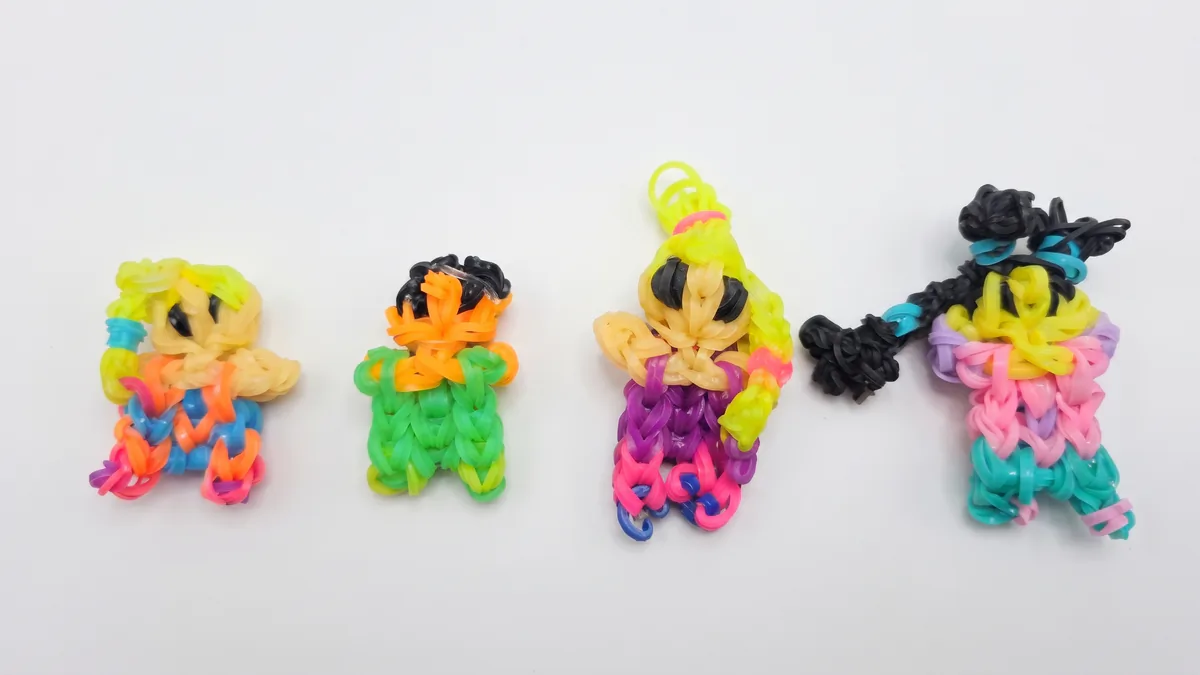 Four loom-band figures in rainbow colours, kid-made, sold as charms