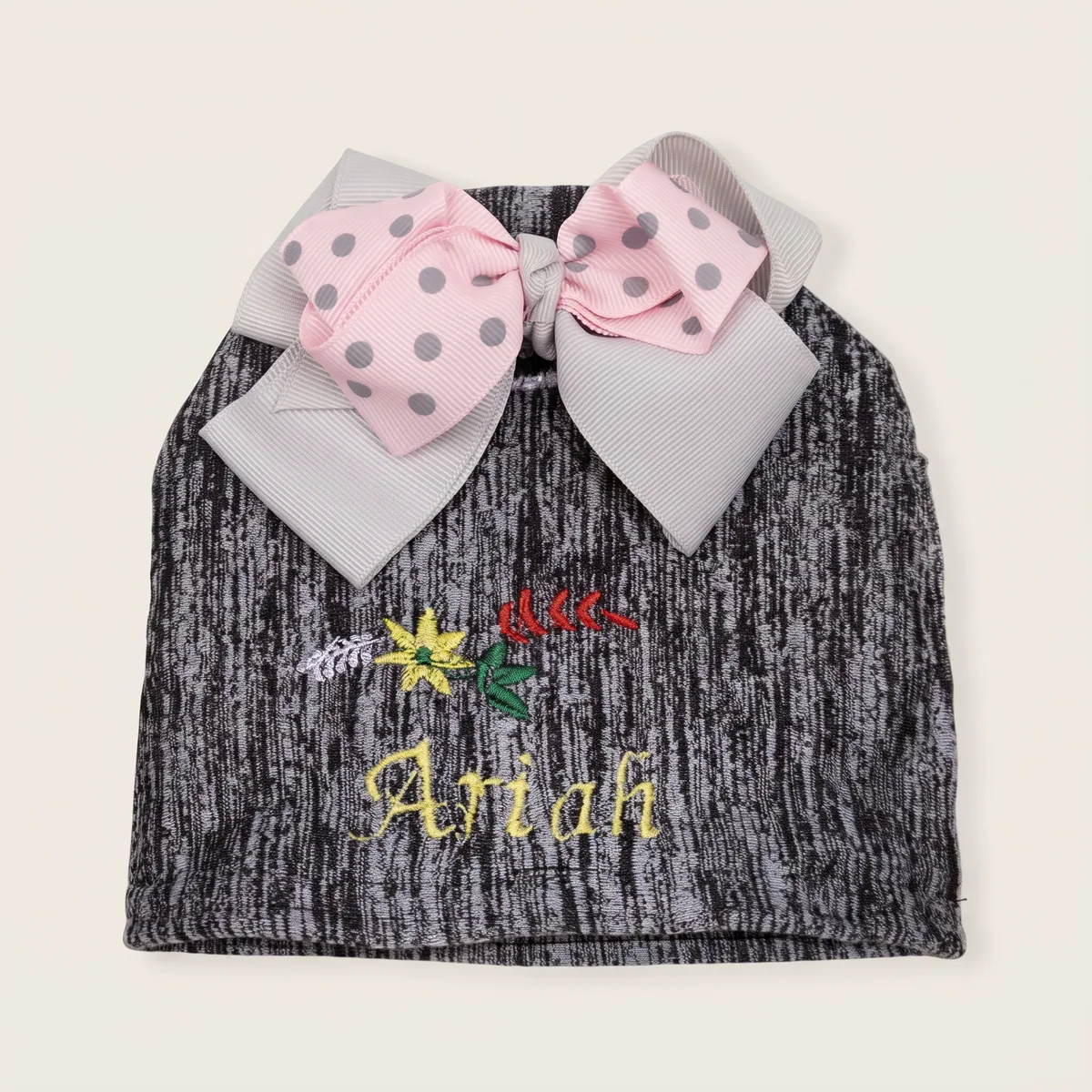 Heather-grey baby knit hat with embroidered "Ariah" and pastel polka-dot ribbon bow