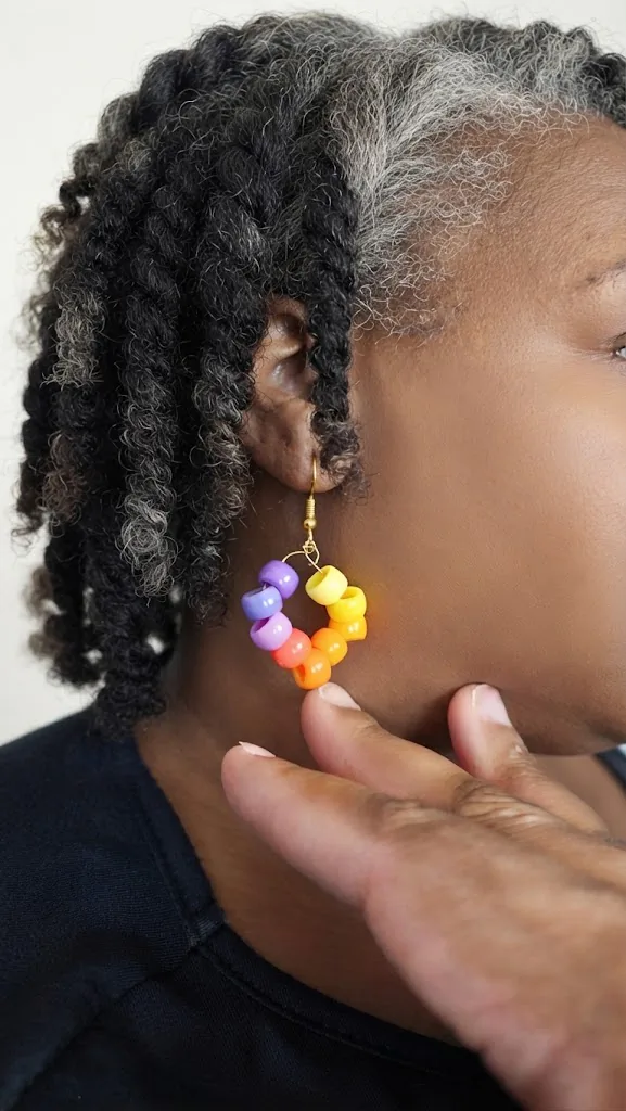 Handmade bead-and-wire earring photographed on the ear
